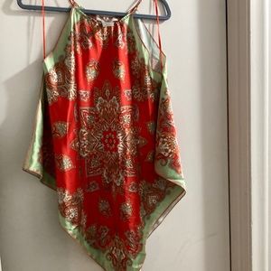 Lady’s sleeveless handkerchief cut at the bottom An orange/ lime green pattern